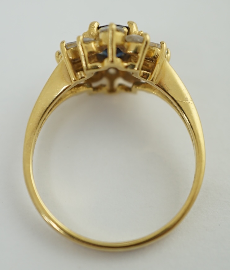 A modern 18ct gold, sapphire and diamond oval cluster ring